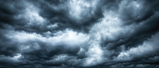 Obraz premium Dramatic storm clouds gathering overhead in the sky creating a dark and ominous atmosphere nature photography from below