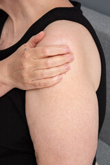 Elderly plump woman holding her forearms. Joint pain