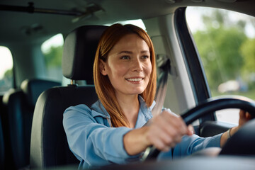 Happy woman enjoying in driving car.