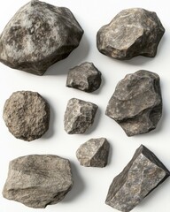Fototapeta premium Assortment of Gray Rocks on White Background Studio Shot Top Down View Geology Mineralogy Science Education