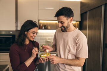 Couple Enjoying Together In Kitchen