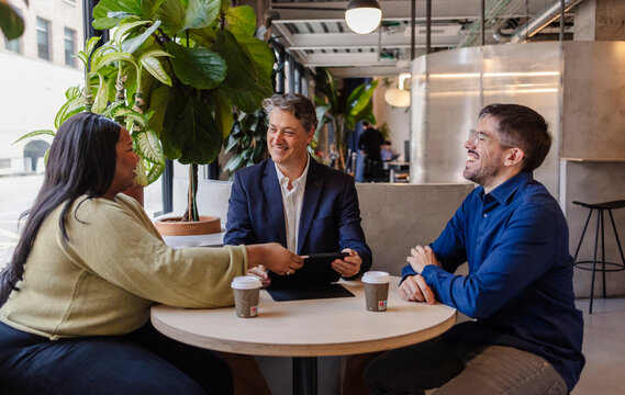 Business people having a meeting in a modern office cafeteria