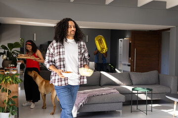 Obraz premium Man carrying snacks while woman and child with balloon prepare for celebration