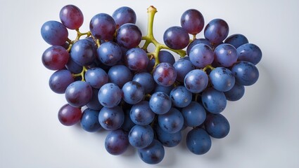 Fototapeta premium Healthy Fruit Display: Isolated Red Grapes from Vine against Blue Background