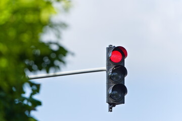 Stop red light on traffic lights. Isolated on blue background. Copy space.
