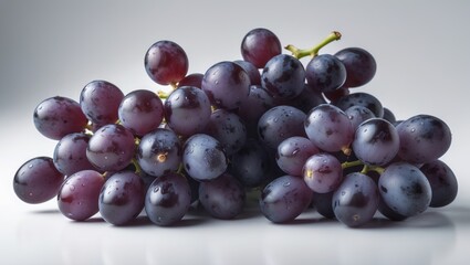 Fototapeta premium Black grapes set apart on a white surface