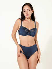 Fototapeta premium Sexy girl model in a beautiful swimsuit, fashion shooting in the studio.