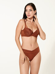 Fototapeta premium Sexy girl model in a beautiful swimsuit, fashion shooting in the studio.