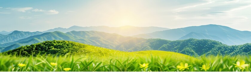 Fototapeta premium Lush green hills and mountains under a bright sunrise with clear skies and yellow flowers in the foreground.