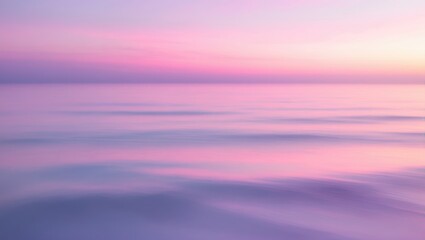Obraz premium Minimalist pink and purple sunset sky above the sea with blurred shoreline and gentle ocean waves