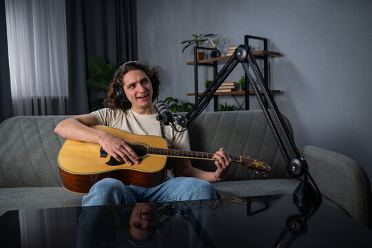 Man Recording Music Podcast with Acoustic Guitar and Microphone