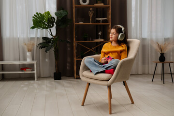 Obraz premium Young Girl Enjoying Music With Stylish Headphones