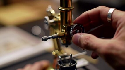 Watchmaker Adjusting a Vintage Microscope