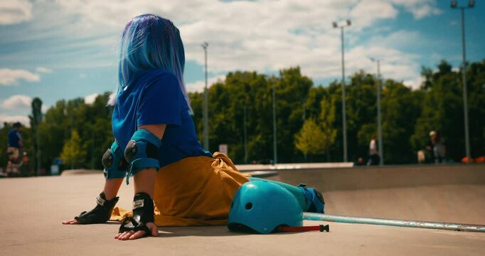 Teenager Girl with Blue Hair Chilling at Skate Park with Roller Blades. Training Hobby Active Lifestyle Youth Culture Concept