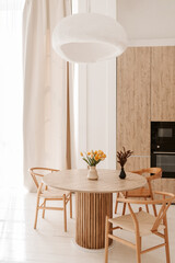 cozy light kitchen with a dining table and chairs