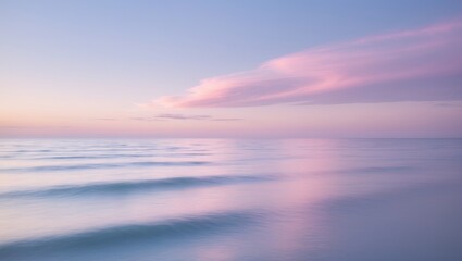 Peaceful long exposure water landscape showcasing soft waves and a colorful cloudscape