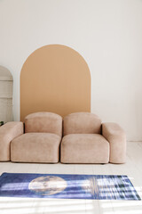 Interior of light modern living room with beige couch