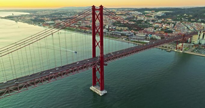 Aerial view of 25 de Abril bridge over the Tagus River at sunset in Lisbon, Portugal