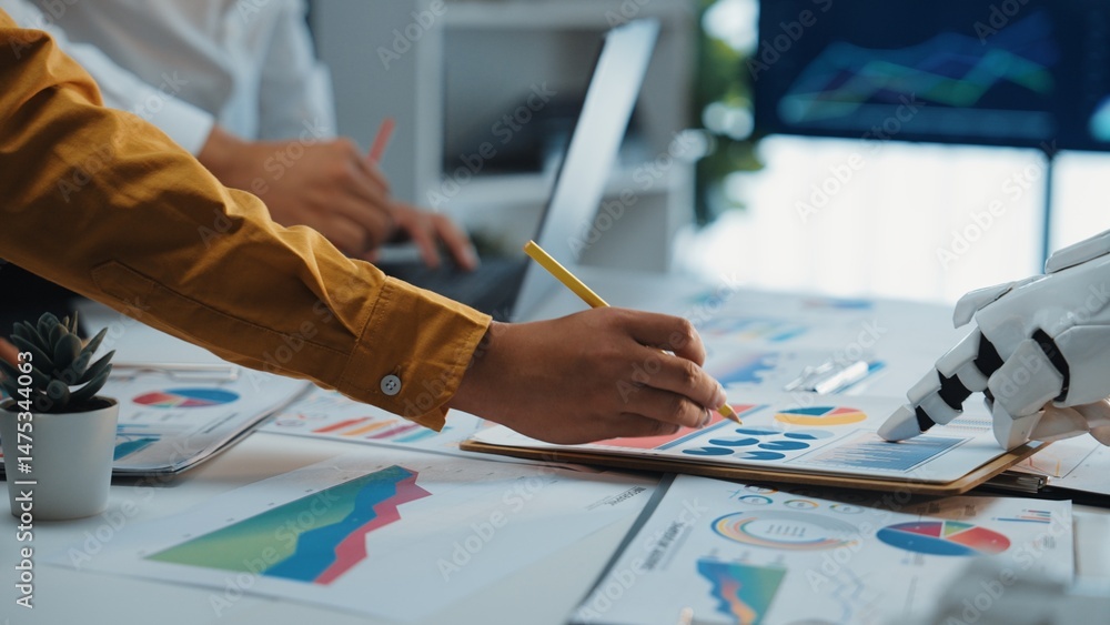 Poster a dynamic office scene where a business team collaborates on data analysis, featuring a robotic hand