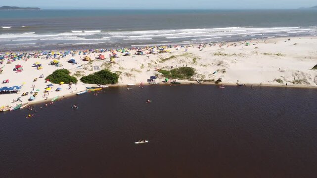 4K Drone Pullback Over Beach, River and Ocean at Guarda do Emba&uacute;, Brazil
