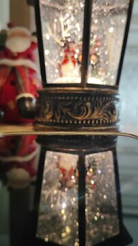 None Vintage Christmas Lantern Snow Globe Video Animation with Festive Decor and Santa Claus Reflection