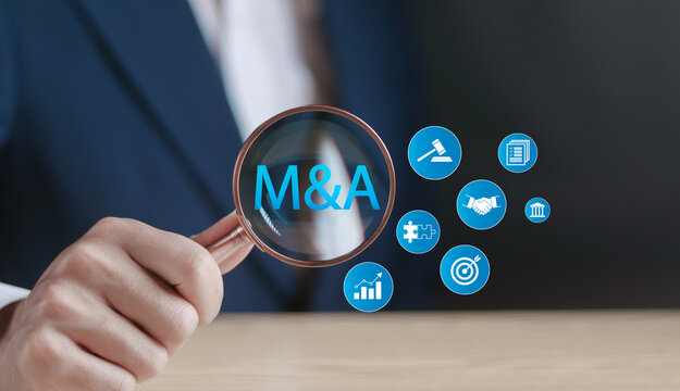 Mergers and acquisitions business concept. M and A deal partnership. Enhance the company's growth and stability. Businessman with M and A text on on virtual screen.