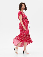 Pregnant girl model in stylish clothes on white background in studio.