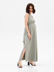 Pregnant girl model in stylish clothes on white background in studio.