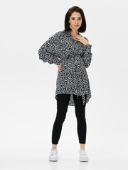 Pregnant girl model in stylish clothes on white background in studio.