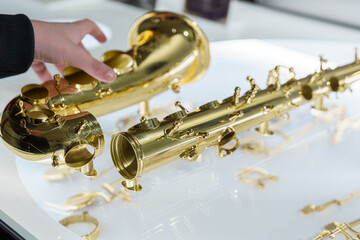 Exploring the intricate details of a golden saxophone in a well-lit display area