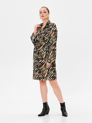 Pregnant girl model in stylish clothes on white background in studio.