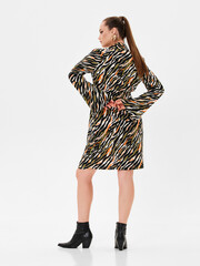 Pregnant girl model in stylish clothes on white background in studio.