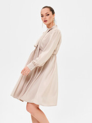 Pregnant girl model in stylish clothes on white background in studio.