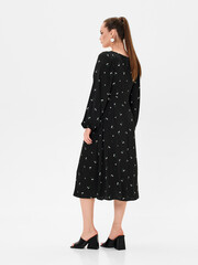 Pregnant girl model in stylish clothes on white background in studio.