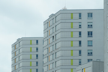 Modern apartment buildings with colorful accents in an urban setting under a cloudy sky