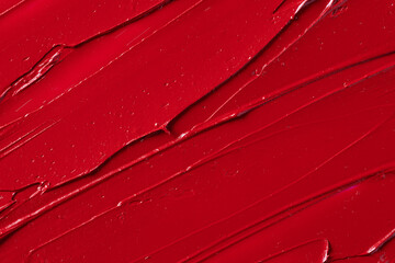 Rich red lipstick texture with smooth application and glossy finish, showcasing vibrant color and...