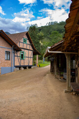 An old half-timbered (Fachwerk) house showcasing traditional German-style architecture, photographed on a bright sunny day with a clear blue sky. A picturesque symbol of cultural heritage and timeless
