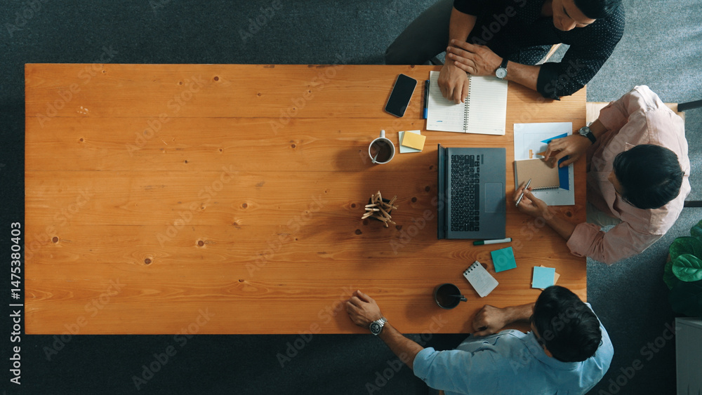 Poster top down aerial view of business team looking at financial graph while shaking hands for making agre