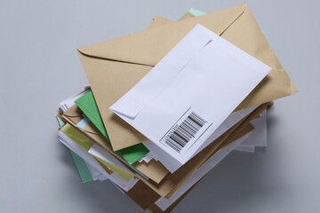 Stack of different paper envelopes on light grey background, above view. Post office