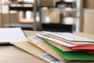 Many different envelopes on table in post office. Space for text
