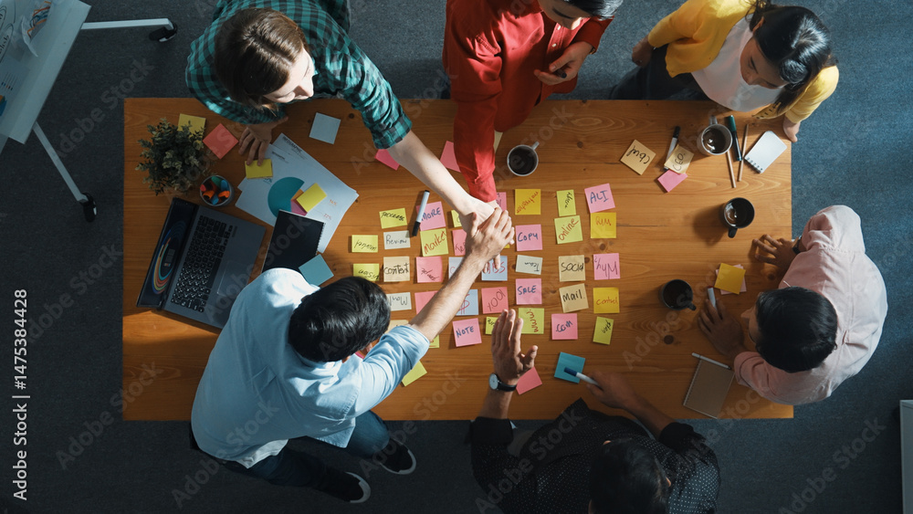 Poster top view of diverse business team putting hand together and clapping hand while brainstorming market