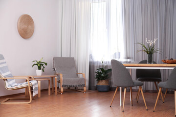 Window with stylish curtains in living room interior