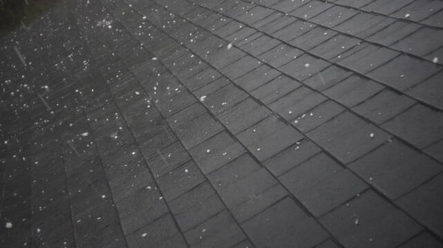 Hailstorm causing roof damage to house 