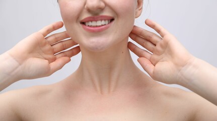 Woman with beautiful collarbones and neck on light background, closeup