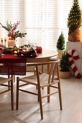 Christmas table setting with stylish dishware and festive decor indoors