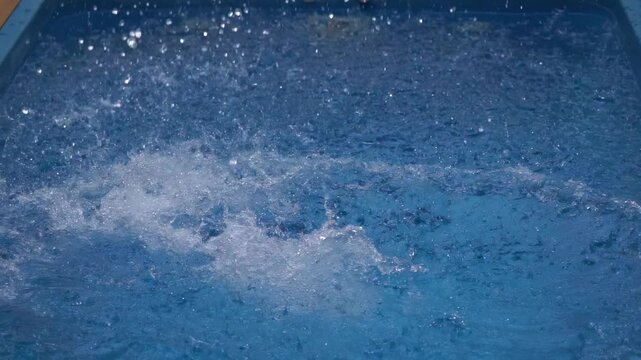 Splashing joy in a bright blue pool on a sunny day with friends and laughter