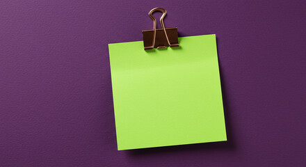 Green notepad on purple background with binder clip.