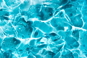Clear blue gel texture with abstract fluid patterns
