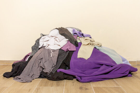 Messy Pile of Colorful Clothes on Floor Waiting for Laundry Day