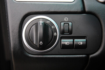 Closeup image of lux car lighting control switch. Light switch on the car dashboard. Dashboard for...